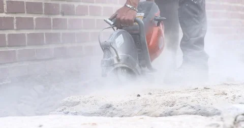 Worker with grinding wheel cutting thru concrete Stock Footage 78676035
