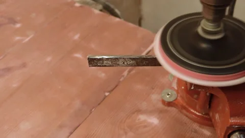 The worker grinds and processes the iron part with a tool with sandpaper. Stock Footage 156174653