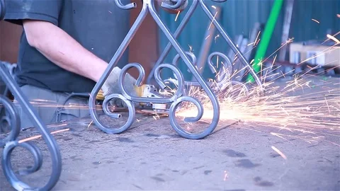 A worker grinds off burrs Stock Footage 97749950