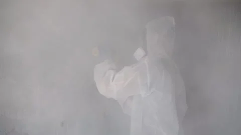 Worker grinds concrete in a protective suit Stock Footage 194844543
