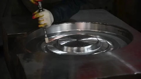 Worker grinds a large metal part with an emery tool Stock Footage 152736896