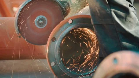 Worker grinds metal construction with circular saw Stock Footage 73428397