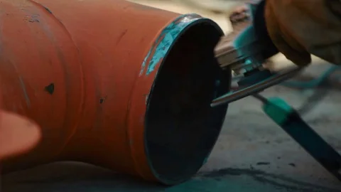 Worker grinds metal construction with circular saw 스톡 동영상 73435316