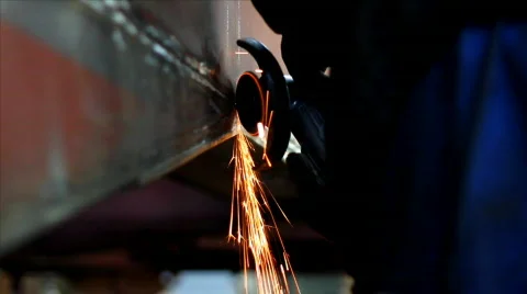 Worker grinds metal construction Stock Footage 873397