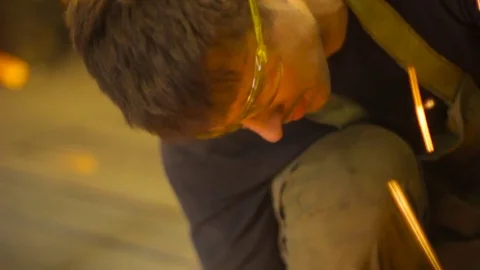 Worker grinds metal Stock Footage 75516441