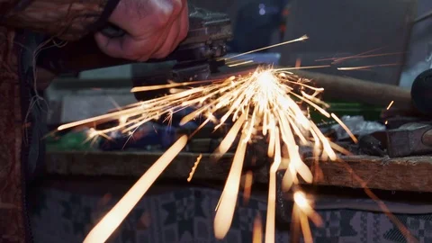 Worker grinds metal with a grinding machine and sparks. Stock Footage 102177245