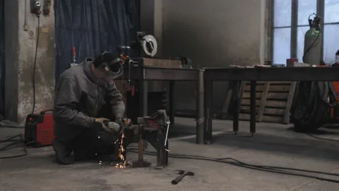 A worker grinds a metal part Stock Footage 225768694