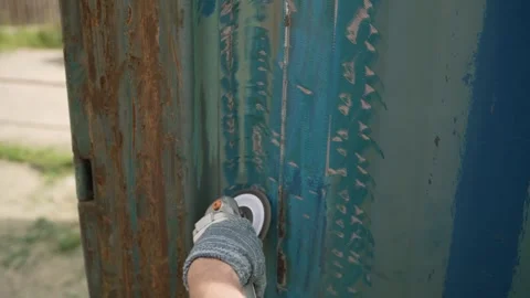Worker Grinds Metal Wall with Power Tool Stock Footage 335278816