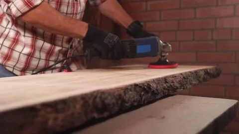 A worker grinds a piece of wood Stock Footage 85394104