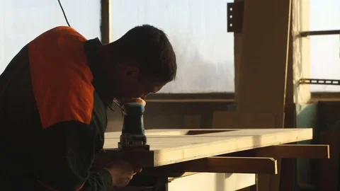 Worker grinds the wood of angular grinding machine Stock Footage 76276682