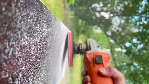 Worker grinds the wood of angular grinding machine. Vertical video for the Video stock 223402880