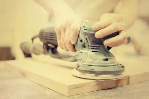 Worker grinds the wood of angular grinding machine 写真素材