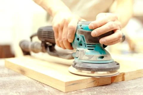 Worker grinds the wood of angular grinding machine 写真素材