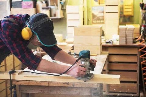 Worker grinds the wood box Worker grinds the wood box of angular grinding ... Stock Photos
