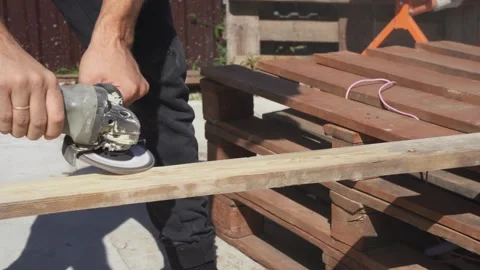 A worker grinds wood with a grinder Stock Footage 314309182