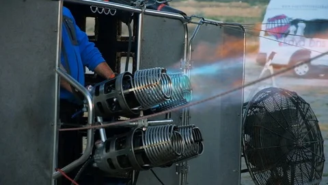 Worker on the ground turns on the fire in the burner, before launching balloon Video stock 105259507