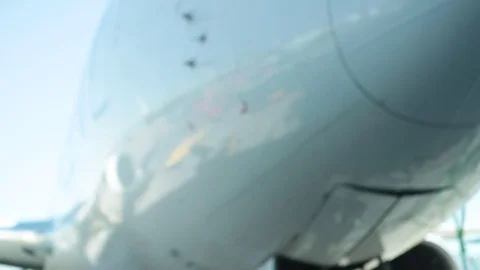 Worker guiding plane on runway Stock Footage 77048547