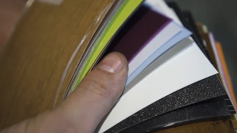 Worker guy shows wood trim samples in office Stock Footage 108501136