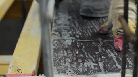 Worker hammering nail into concrete formwork Stock Footage 314234126