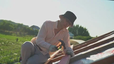 Worker hammering nails into boards. Construction of the roof. Roof battens. Stock Footage 266239837