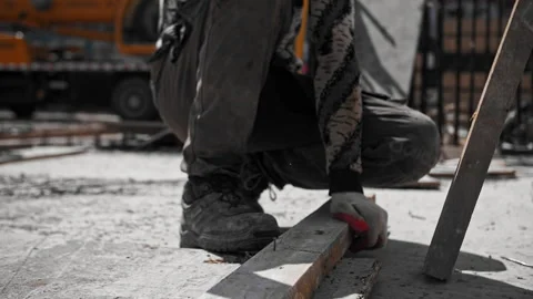 Worker hammers a nail with a hammer Stock Footage 242030719