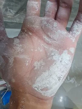 Worker Hand Covered with White Construction Powder Close Up 스톡 사진