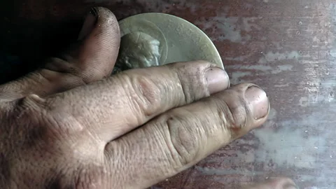 Worker Hand Handling Wax Saint Medallion for Bell Casting Mold - 4K Stock Footage 340171375