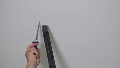 Worker hand with handsaw and vacuum cleaner sawing hole in gypsum ceiling Stock Footage 122414853