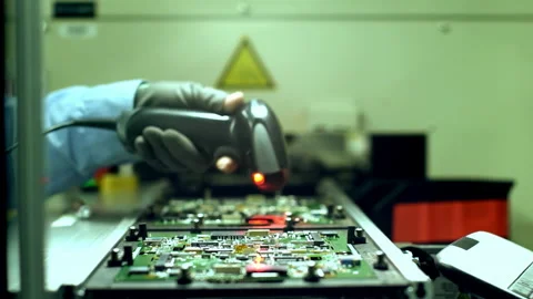 Worker Hand Holding Bar Code Scanner over Printed Circuit Boards. 4K. Stock Footage 154609812