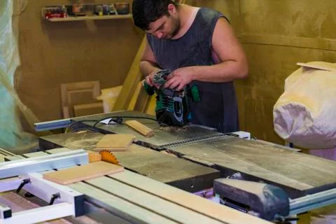 Worker with a hand mill. Stock Photos