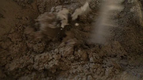 Worker hand-mixing the concrete Stock Footage 75771034