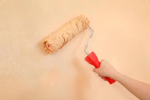 Worker hand with paintroller 写真素材