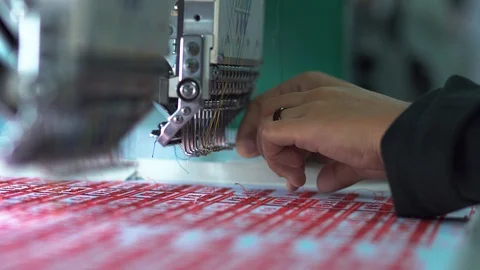 A worker hand put in thread on needle at Garment Manufacturers Stock Footage 124181421