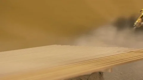 Worker hand sprays polish to mdf planks Stock Footage 83618400