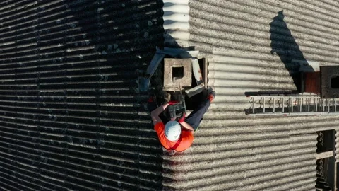 Worker Handling Asbestos-Contained Materials On The Roof.  ascending drone Vidéo 161134816