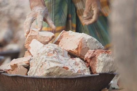 Worker handling clay bricks at a construction site in rural area Stock Photos
