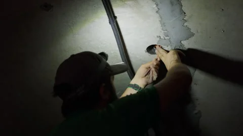 Worker handling electrical wires in concrete ceiling during construction Stock-Footage 343449735
