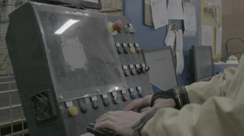 Worker with hands on console in factory Stock Footage