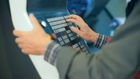 Worker hands on the control panel of a computer numerical control programmable Video stock 70709009