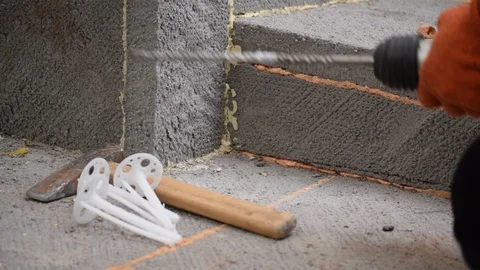 Worker hands drilling a hole on house foundation with perforator Stock Footage 88292872