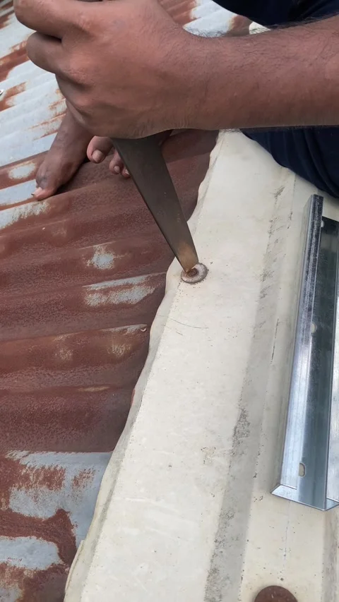 Worker hands fixing corrugated tin roof sheet with tool close up shot Stock Footage 340140667