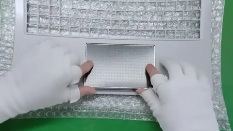 Worker hands in gloves installing touchpad into laptop case Видео 347981378