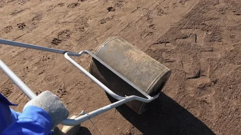 Worker hands with gloves push heavy roller earth compactor. Handheld motion Stock Footage 146211766