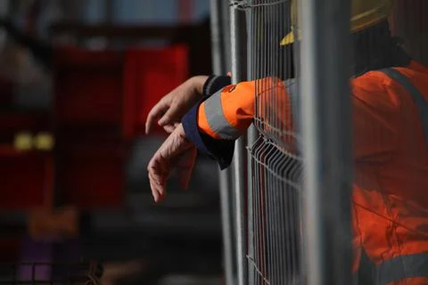 Worker hands in grid Foto stock