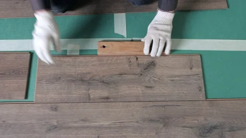 A worker hands knocking on a laminate connecting the panels with a Lock Click Stock Footage 165415126