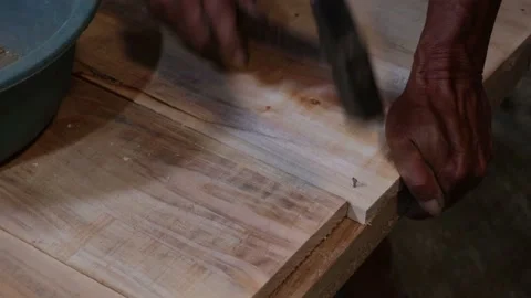 Worker Hands Nailing Nail To The Soft Surface Of A Wooden Plank Using A Hammer Stock Footage 161538781