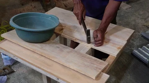 Worker Hands Nailing Nail To The Soft Surface Of A Wooden Plank Using A Hammer Stock Footage 161539275