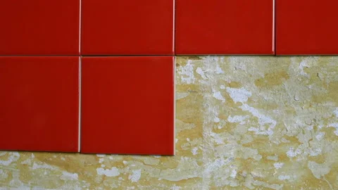 Worker hands placing small red ceramic tile on wall during repair kitchen or Stock Footage 152814712