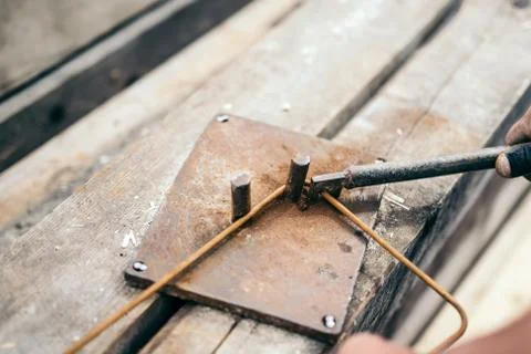 Worker hands using steel wire and pincers to bend steel bars Stock Photos