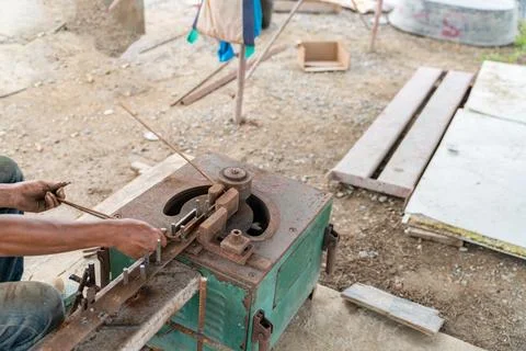 Worker hands working by using rebar bender machine reinforcing concrete metal Stock Photos